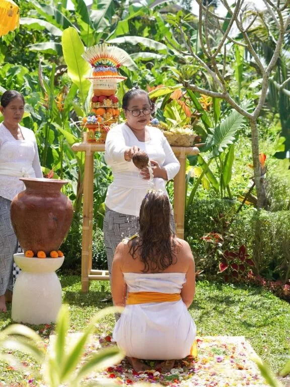 Balinese woman during Melukat water purification at temple in Ubud – Bali healing ceremony