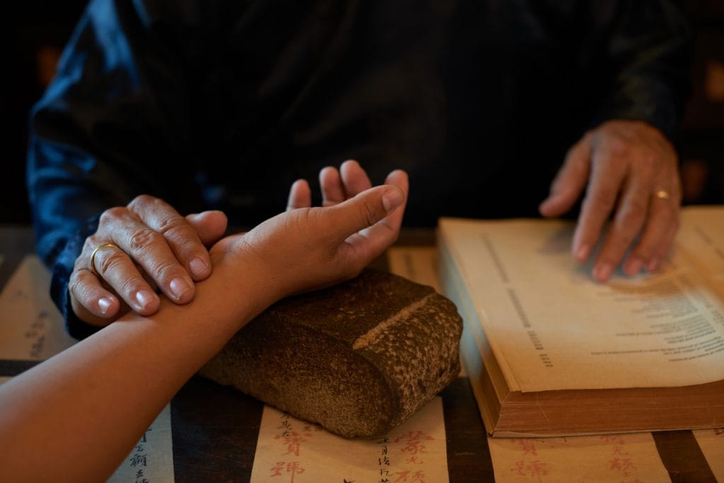 A serene Ayurvedic consultation at Goddess Retreats, where a practitioner provides personalized wellness guidance in a tranquil, healing environment.