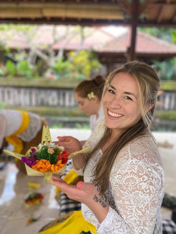Guest participating in a traditional Balinese offering and mandala workshop during a Bali retreat