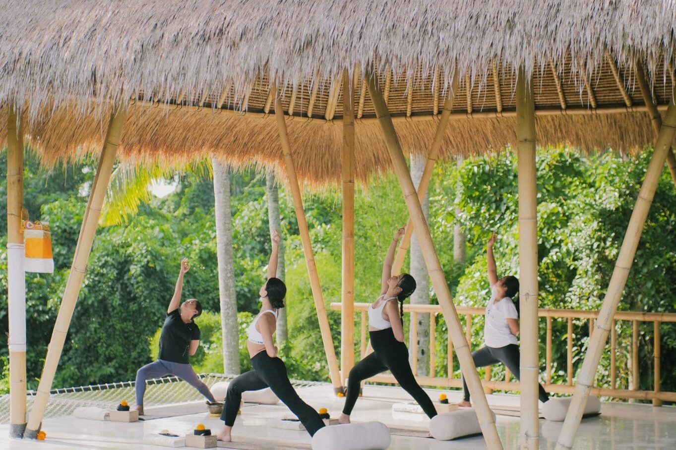 Spacious and serene yoga shala at Goddess Retreats, with wooden floors, large windows, and mats ready for a transformative yoga session