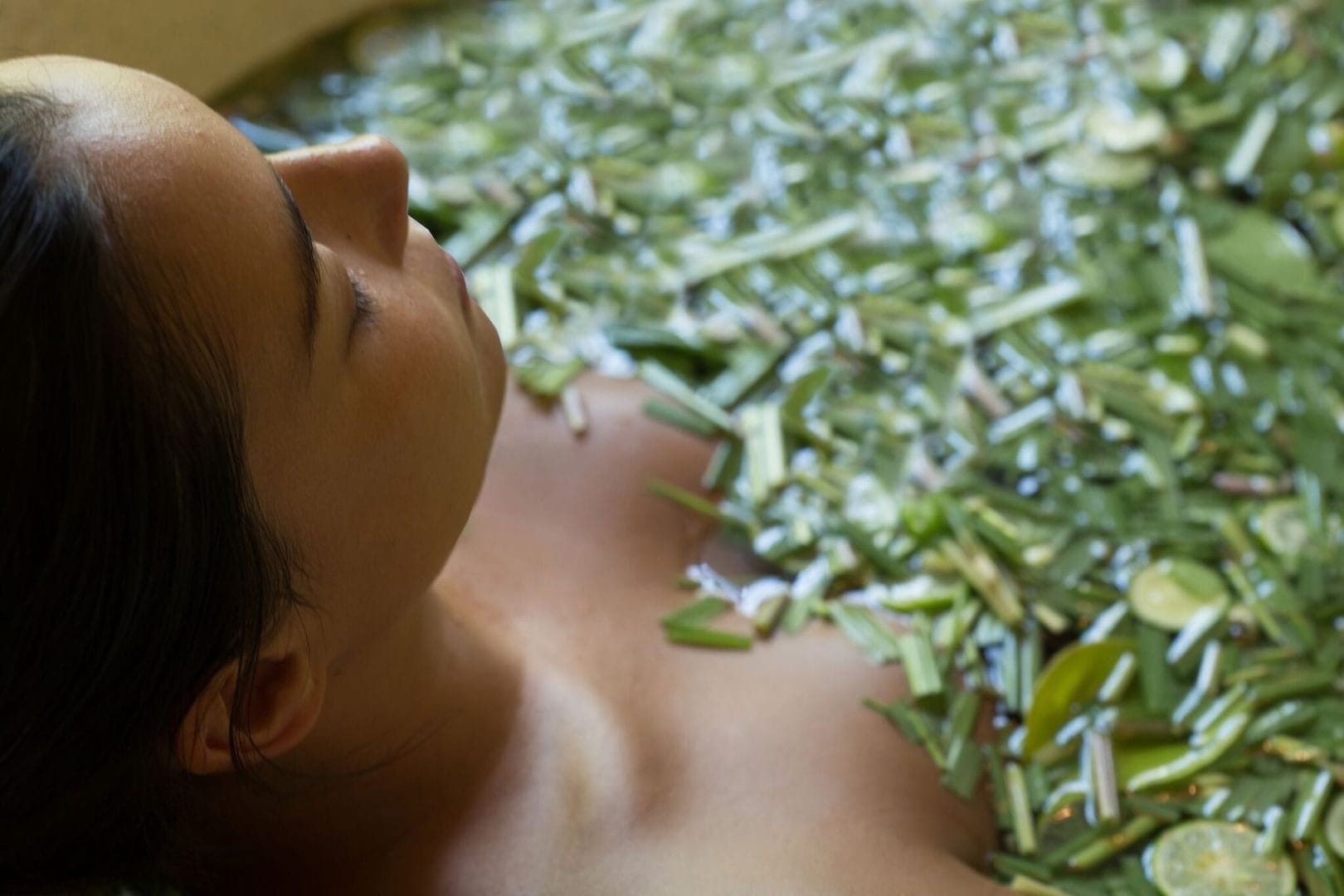 Serene herbal spa bath at a Ubud health retreat, surrounded by lush greenery and relaxing ambiance.