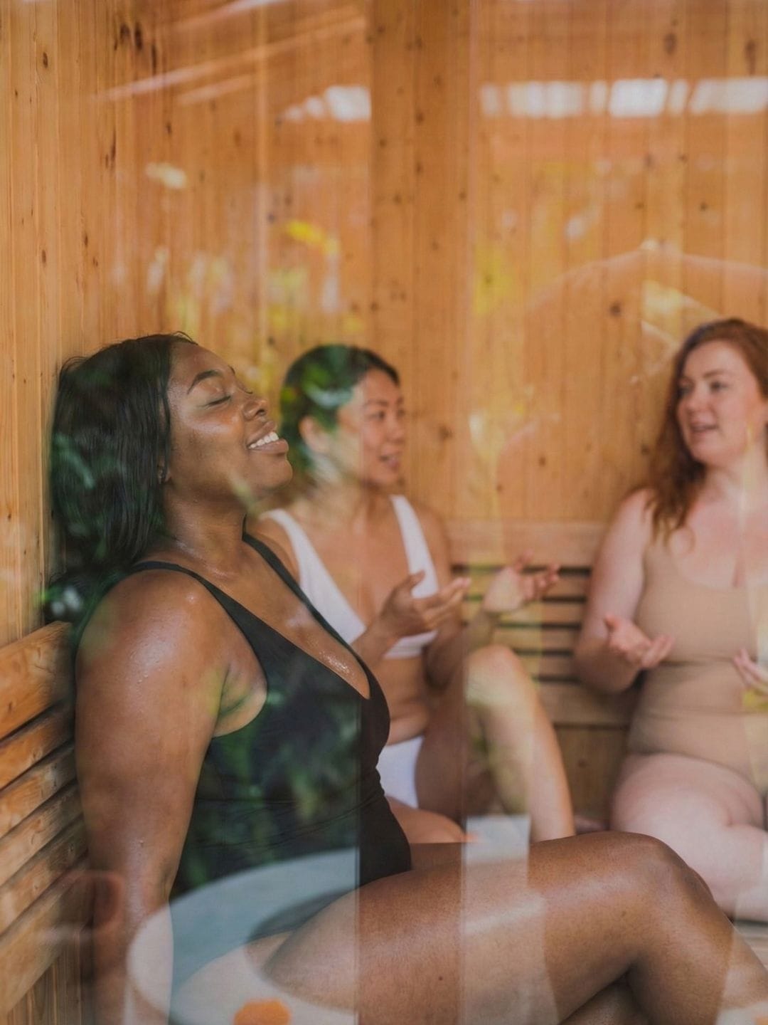 Women enjoying a relaxing sauna session together at a wellness retreat in Bali.