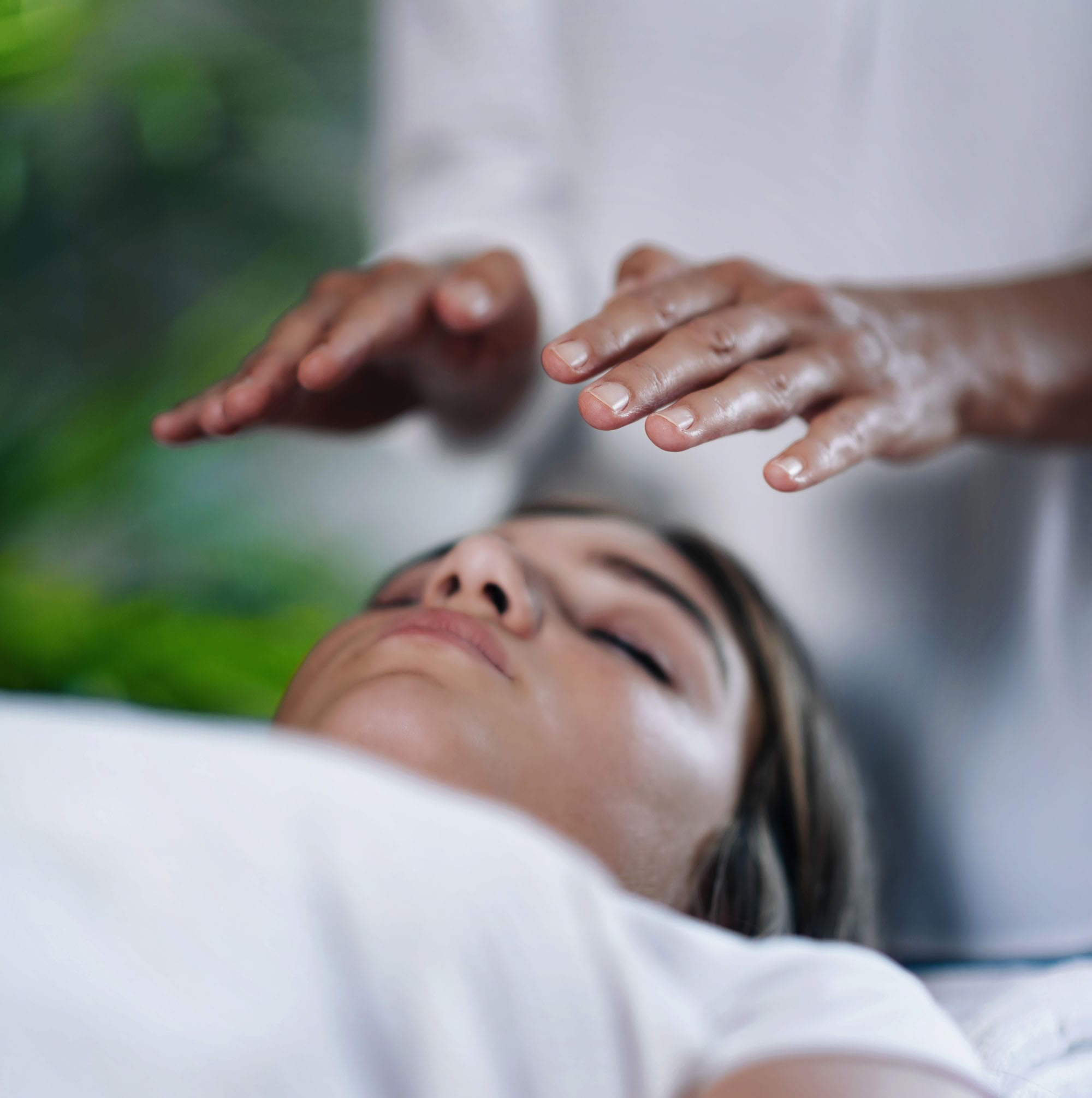 A woman recieving REiki healing